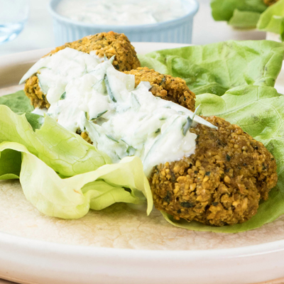 Crispy falafel wrap with cucumber yogurt sauce dripping