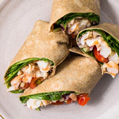 Fresh shrimp salad wrap with lettuce and vegetables