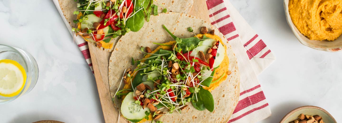 Vegetarian wrap with orange sweet potato hummus