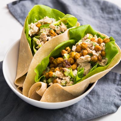 Tuna wrap cut diagonally displaying crispy roasted chickpeas and fresh vegetables